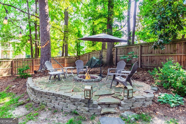 706 Powder Springs St SE, Smyrna, GA 30080 - fenced backyard featuring an outdoor fire pit and a patio area