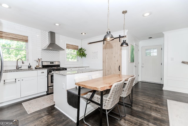 706 Powder Springs St SE, Smyrna, GA 30080 - kitchen featuring wall chimney exhaust hood, stainless steel range with gas stovetop, ornamental molding, backsplash, and light stone counters