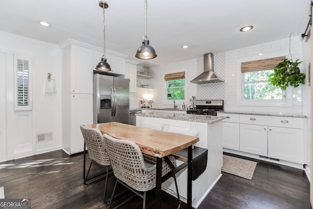 706 Powder Springs St SE, Smyrna, GA 30080 - kitchen featuring wall chimney exhaust hood, stainless steel appliances, backsplash, white cabinets, and ornamental molding