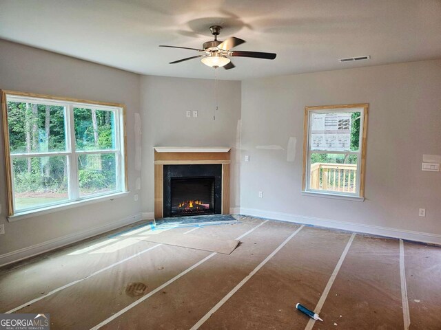 305 Melanie Ct, Bowdon, GA 30108 - unfurnished living room with a fireplace with flush hearth and ceiling fan