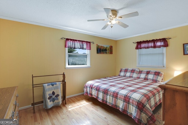 16 Lois Ln, Hayesville, NC 28904 - bedroom with wood finished floors, a textured ceiling, crown molding, and a ceiling fan
