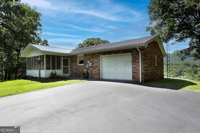 16 Lois Ln, Hayesville, NC 28904 - ranch-style house featuring a sunroom, a garage, asphalt driveway, brick siding, and a front lawn