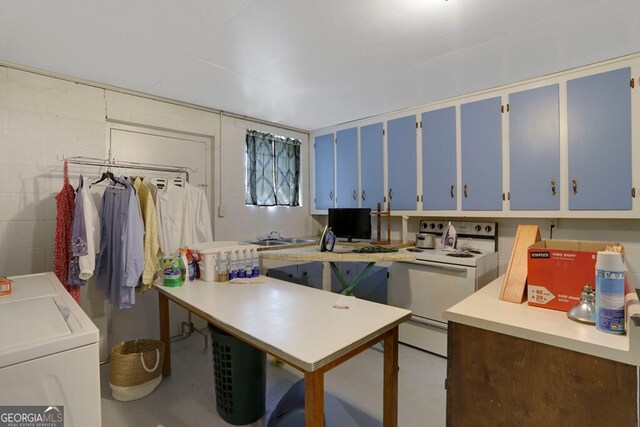 16 Lois Ln, Hayesville, NC 28904 - kitchen featuring white range with electric stovetop, blue cabinetry, washing machine and dryer, light countertops, and concrete flooring