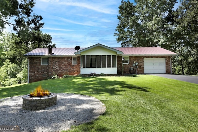 16 Lois Ln, Hayesville, NC 28904 - ranch-style house with an outdoor fire pit, a garage, brick siding, and a front yard