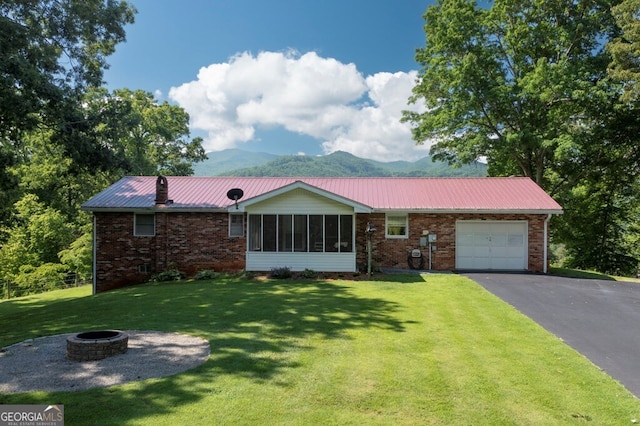 16 Lois Ln, Hayesville, NC 28904 - ranch-style home with a fire pit, a garage, and brick siding