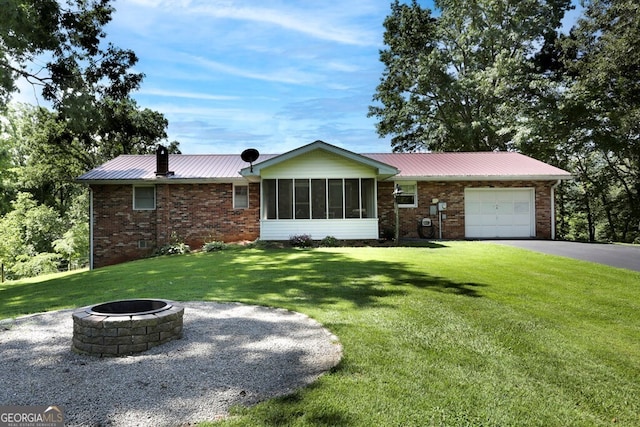 16 Lois Ln, Hayesville, NC 28904 - ranch-style home featuring an outdoor fire pit, an attached garage, brick siding, and a front lawn