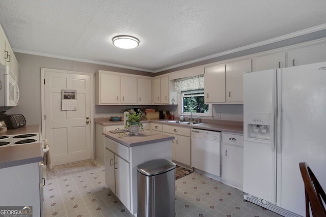 16 Lois Ln, Hayesville, NC 28904 - kitchen featuring white appliances, crown molding, a textured ceiling, a kitchen island, and white cabinetry