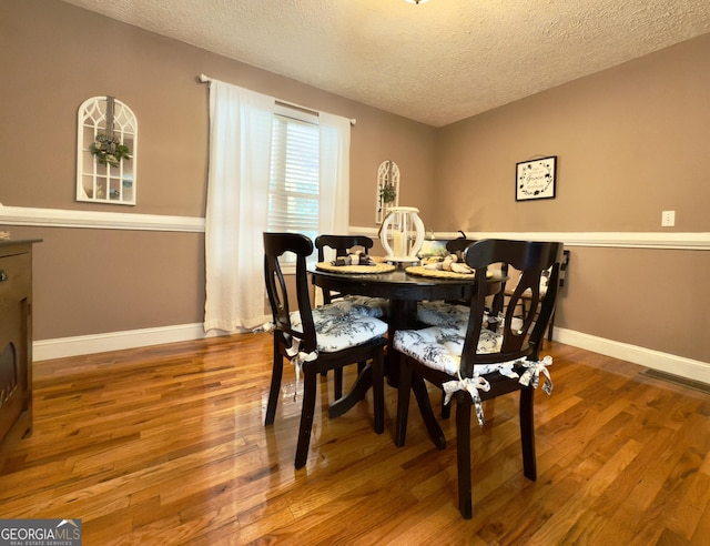 1780 Double Bridge Rd, Demorest, GA 30535 - dining space featuring a textured ceiling and wood finished floors