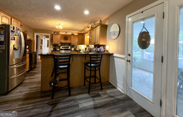 1780 Double Bridge Rd, Demorest, GA 30535 - kitchen with appliances with stainless steel finishes, a peninsula, dark countertops, dark wood-style floors, and a textured ceiling