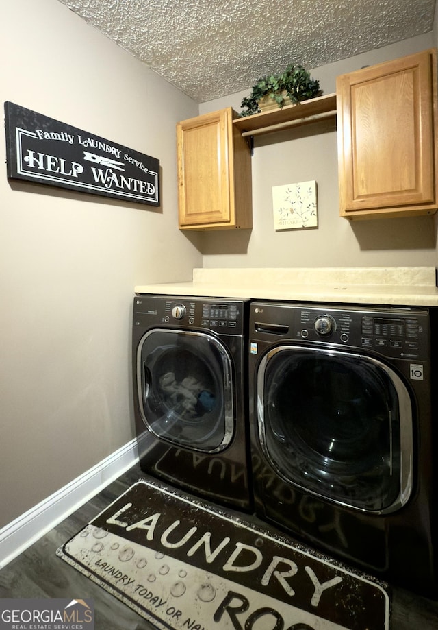 1780 Double Bridge Rd, Demorest, GA 30535 - laundry area featuring washer and dryer, cabinet space, wood finished floors, and a textured ceiling