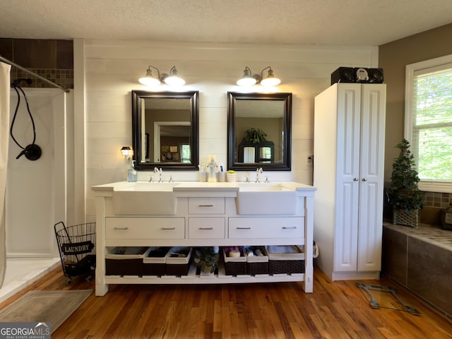 1780 Double Bridge Rd, Demorest, GA 30535 - full bathroom with double vanity, wood finished floors, a shower, a textured ceiling, and a bath