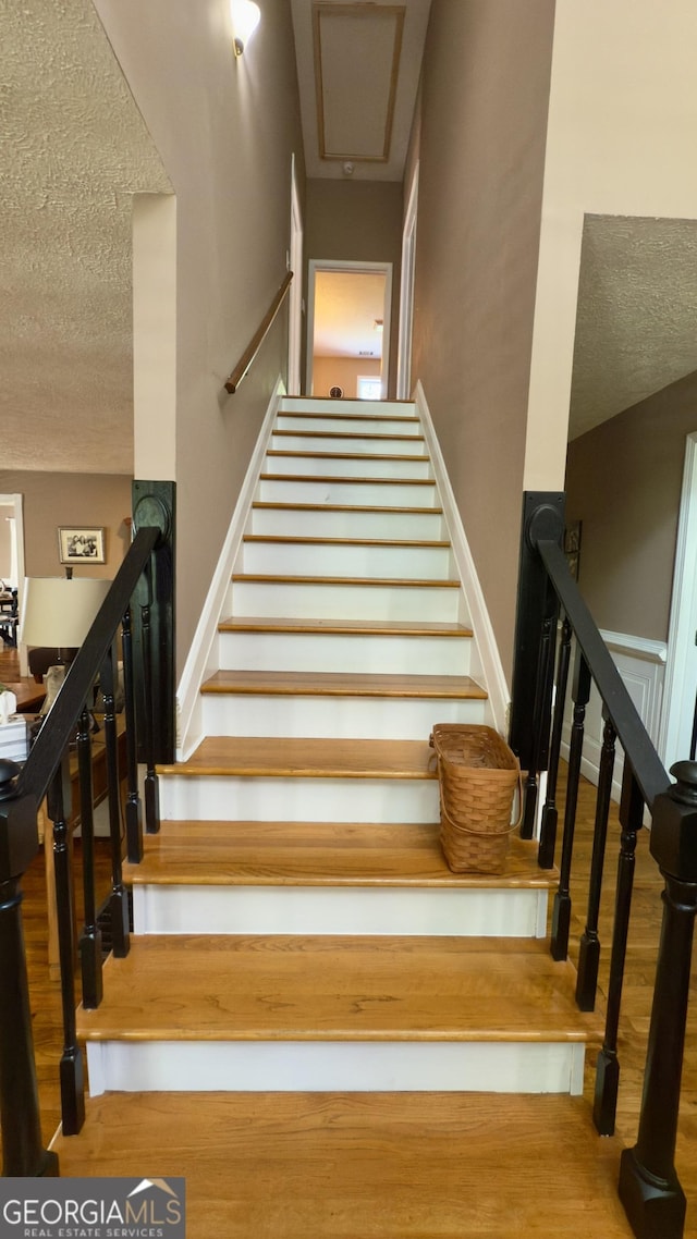 1780 Double Bridge Rd, Demorest, GA 30535 - staircase with a textured ceiling and wood finished floors