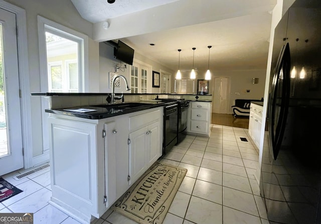 1417 Doe Valley Dr, Lithonia, GA 30058 - kitchen with black appliances, dark countertops, white cabinetry, hanging light fixtures, and light tile patterned floors