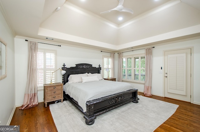 4645 Wykeshire Ct, Cumming, GA 30041 - bedroom featuring dark wood-style floors, multiple windows, a raised ceiling, crown molding, and a ceiling fan