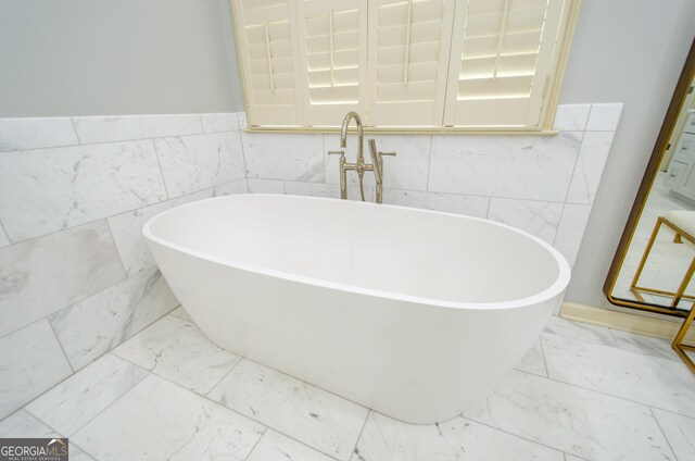 4645 Wykeshire Ct, Cumming, GA 30041 - full bathroom with marble finish flooring, a freestanding tub, and tile walls