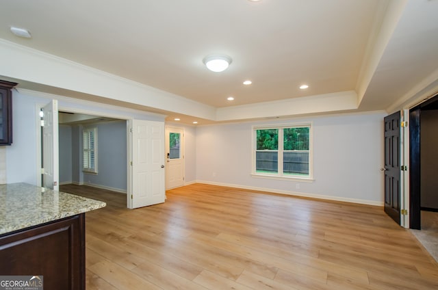4645 Wykeshire Ct, Cumming, GA 30041 - unfurnished living room featuring a raised ceiling, ornamental molding, light wood-style floors, plenty of natural light, and recessed lighting