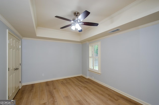 4645 Wykeshire Ct, Cumming, GA 30041 - spare room with a tray ceiling, a ceiling fan, light wood-style floors, and crown molding