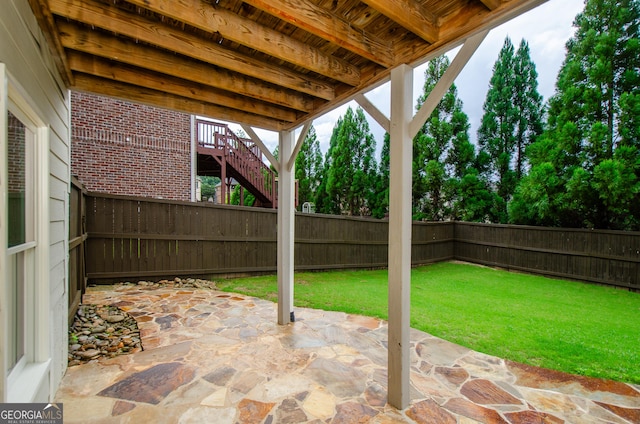 4645 Wykeshire Ct, Cumming, GA 30041 - fenced backyard featuring a patio and stairway
