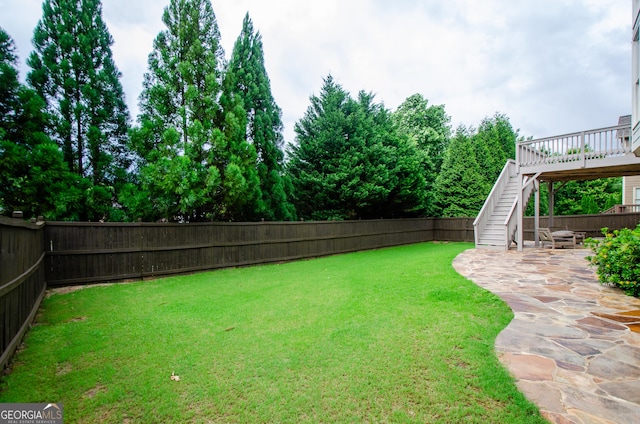 4645 Wykeshire Ct, Cumming, GA 30041 - fenced backyard featuring stairs, a patio, and a wooden deck