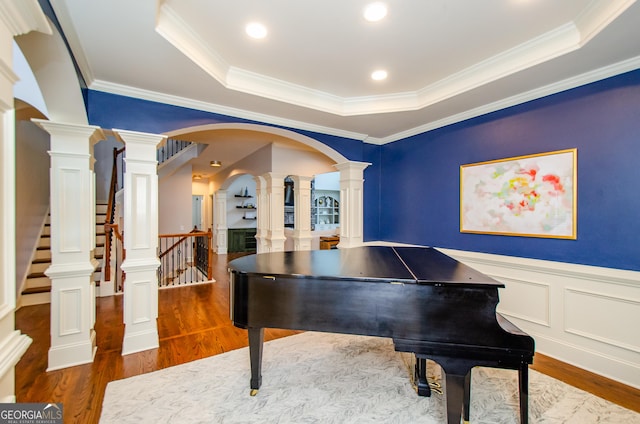 4645 Wykeshire Ct, Cumming, GA 30041 - game room featuring a raised ceiling, decorative columns, wood finished floors, wainscoting, and ornamental molding