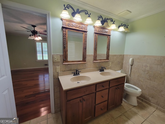 424 Ivey Edwards Ln, Mcdonough, GA 30253 - full bath featuring tile walls, crown molding, double vanity, tile patterned floors, and ceiling fan