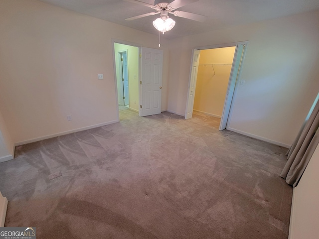 424 Ivey Edwards Ln, Mcdonough, GA 30253 - unfurnished bedroom with light colored carpet, a ceiling fan, and a walk in closet