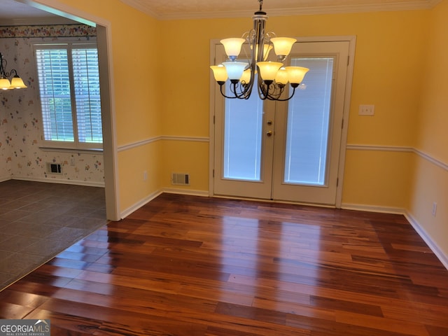424 Ivey Edwards Ln, Mcdonough, GA 30253 - unfurnished dining area featuring a chandelier, dark wood finished floors, wallpapered walls, and ornamental molding