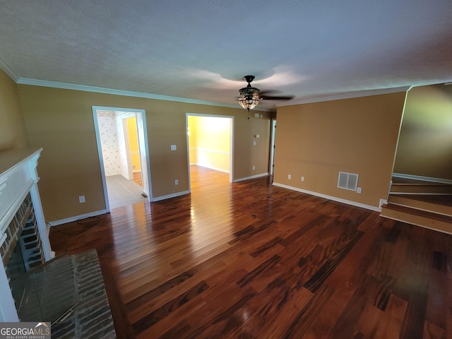424 Ivey Edwards Ln, Mcdonough, GA 30253 - unfurnished living room with a brick fireplace, a ceiling fan, wood finished floors, and crown molding