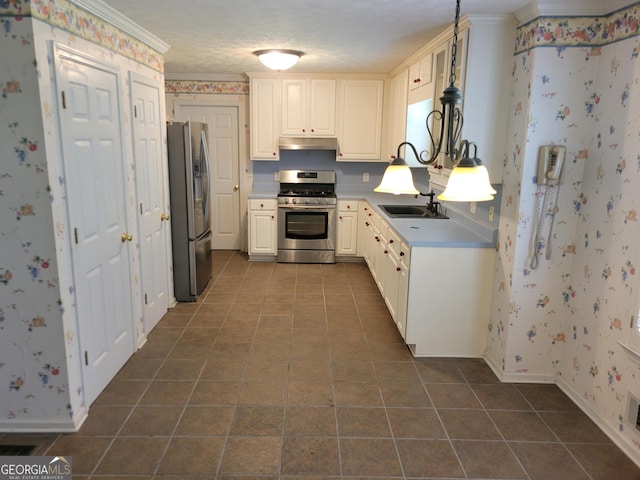 424 Ivey Edwards Ln, Mcdonough, GA 30253 - kitchen featuring appliances with stainless steel finishes, under cabinet range hood, dark tile patterned flooring, wallpapered walls, and light countertops
