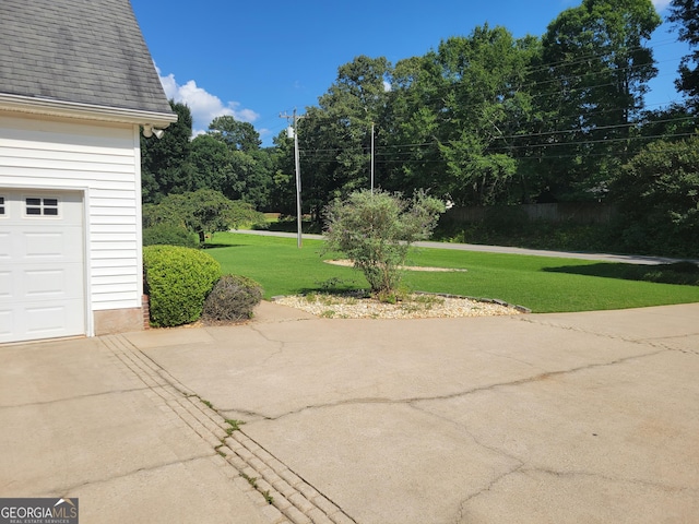 424 Ivey Edwards Ln, Mcdonough, GA 30253 - view of patio featuring a garage and concrete driveway