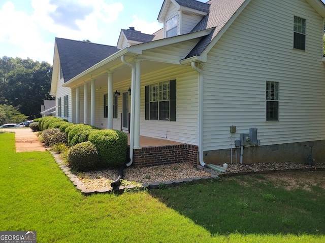 424 Ivey Edwards Ln, Mcdonough, GA 30253 - view of home's exterior with covered porch, a yard, and roof with shingles