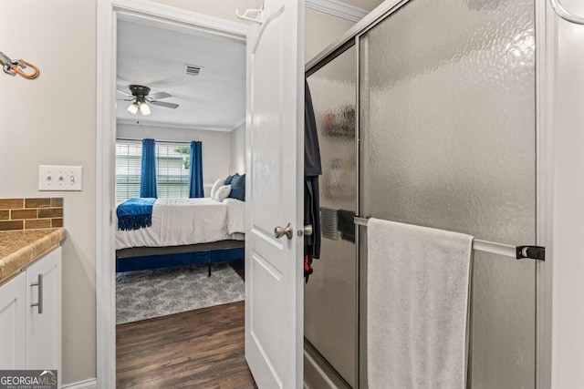 41 Bob White Ln, Newnan, GA 30263 - ensuite bathroom with wood finished floors, ceiling fan, a stall shower, ornamental molding, and vanity
