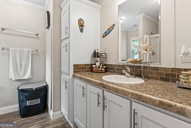 41 Bob White Ln, Newnan, GA 30263 - bathroom with ornamental molding, vanity, tasteful backsplash, and wood finished floors