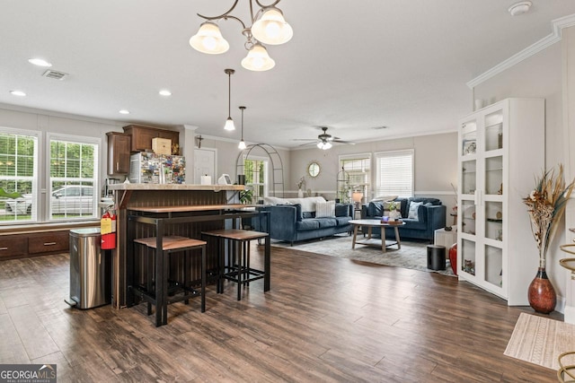 41 Bob White Ln, Newnan, GA 30263 - kitchen with crown molding, healthy amount of natural light, refrigerator, dark wood-style floors, and a breakfast bar area