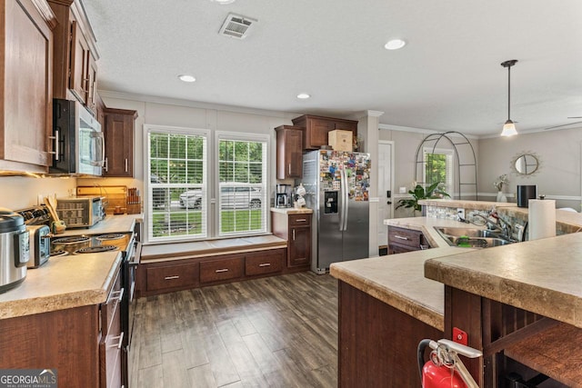 41 Bob White Ln, Newnan, GA 30263 - kitchen featuring appliances with stainless steel finishes, ornamental molding, light countertops, dark wood-type flooring, and pendant lighting