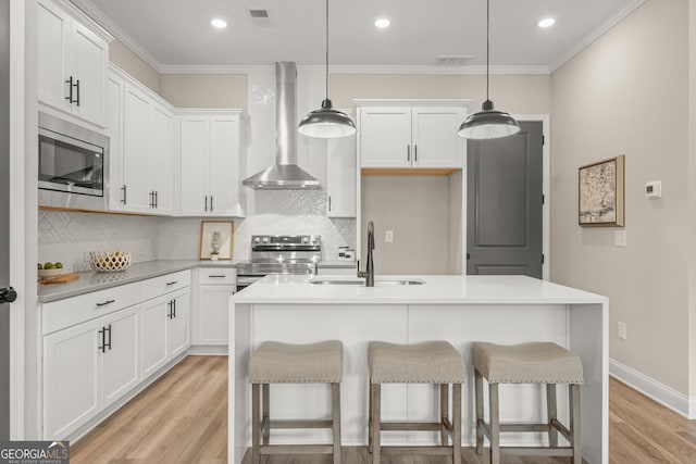 947 Willingham Dr Unit 2, Hapeville, GA 30354 - kitchen featuring appliances with stainless steel finishes, wall chimney range hood, decorative backsplash, crown molding, and light wood-style flooring
