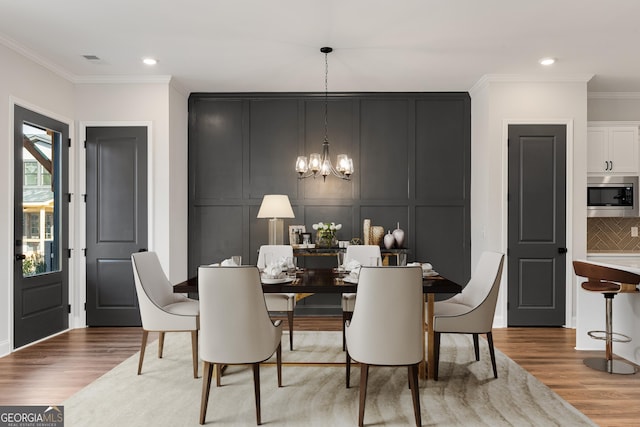 945 Willingham Dr Unit 3, Hapeville, GA 30354 - dining room with a decorative wall, a chandelier, light wood-style flooring, crown molding, and recessed lighting