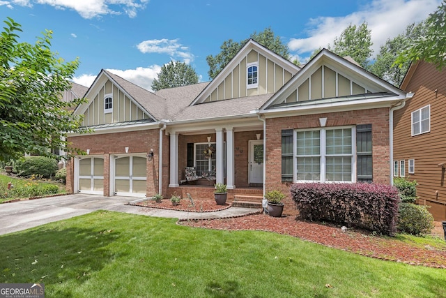 7769 Copper Kettle Way, Flowery Branch, GA 30542 - craftsman inspired home featuring board and batten siding, brick siding, concrete driveway, a front yard, and an attached garage