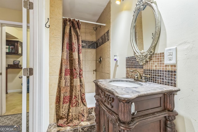7769 Copper Kettle Way, Flowery Branch, GA 30542 - bathroom featuring vanity, tiled shower / bath combo, and tasteful backsplash