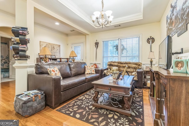 7769 Copper Kettle Way, Flowery Branch, GA 30542 - living area with ornamental molding, a chandelier, wood finished floors, a wainscoted wall, and a tray ceiling