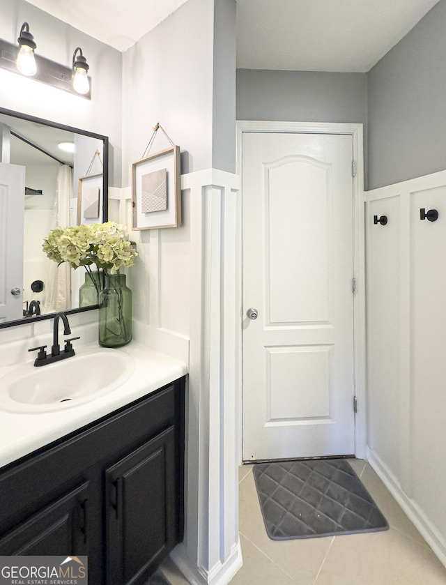184 Fashion Xing, Mcdonough, GA 30252 - bathroom featuring vanity, tile patterned floors, wainscoting, and a decorative wall