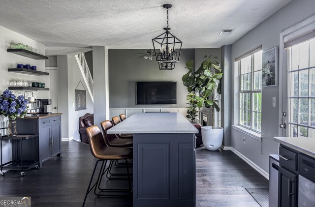 184 Fashion Xing, Mcdonough, GA 30252 - dining room featuring dark wood-style floors, a textured ceiling, and a chandelier