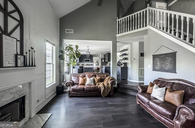 184 Fashion Xing, Mcdonough, GA 30252 - living area with high vaulted ceiling, dark wood-style flooring, and a premium fireplace