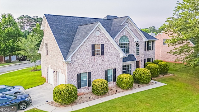 184 Fashion Xing, Mcdonough, GA 30252 - view of front of house with concrete driveway, an attached garage, a front yard, and brick siding