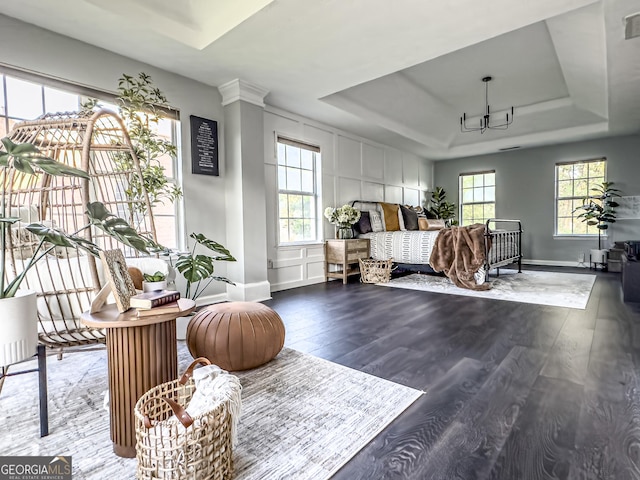 184 Fashion Xing, Mcdonough, GA 30252 - living area with a tray ceiling, plenty of natural light, wood finished floors, and a chandelier