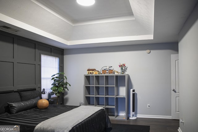 184 Fashion Xing, Mcdonough, GA 30252 - bedroom featuring a raised ceiling and dark wood finished floors