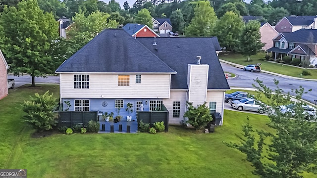 184 Fashion Xing, Mcdonough, GA 30252 - back of house with a chimney, a yard, and a shingled roof