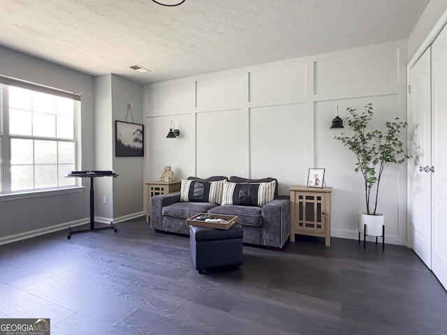 184 Fashion Xing, Mcdonough, GA 30252 - living area with dark wood-type flooring and a textured ceiling
