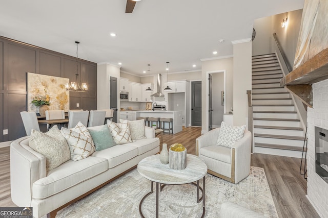937 Willingham Dr Unit 7, Hapeville, GA 30354 - living area with light wood-type flooring, crown molding, stairs, recessed lighting, and ceiling fan