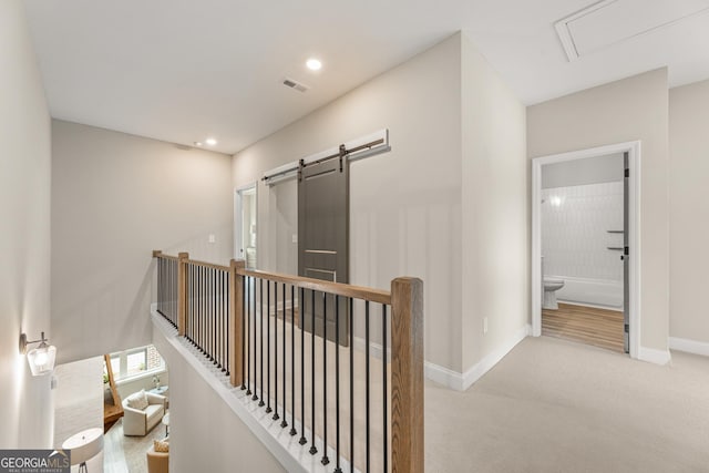 937 Willingham Dr Unit 7, Hapeville, GA 30354 - hall with carpet flooring, an upstairs landing, a barn door, and recessed lighting